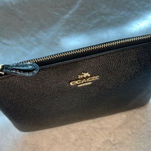 Coach, black wristlet, small and convenient to carry around.